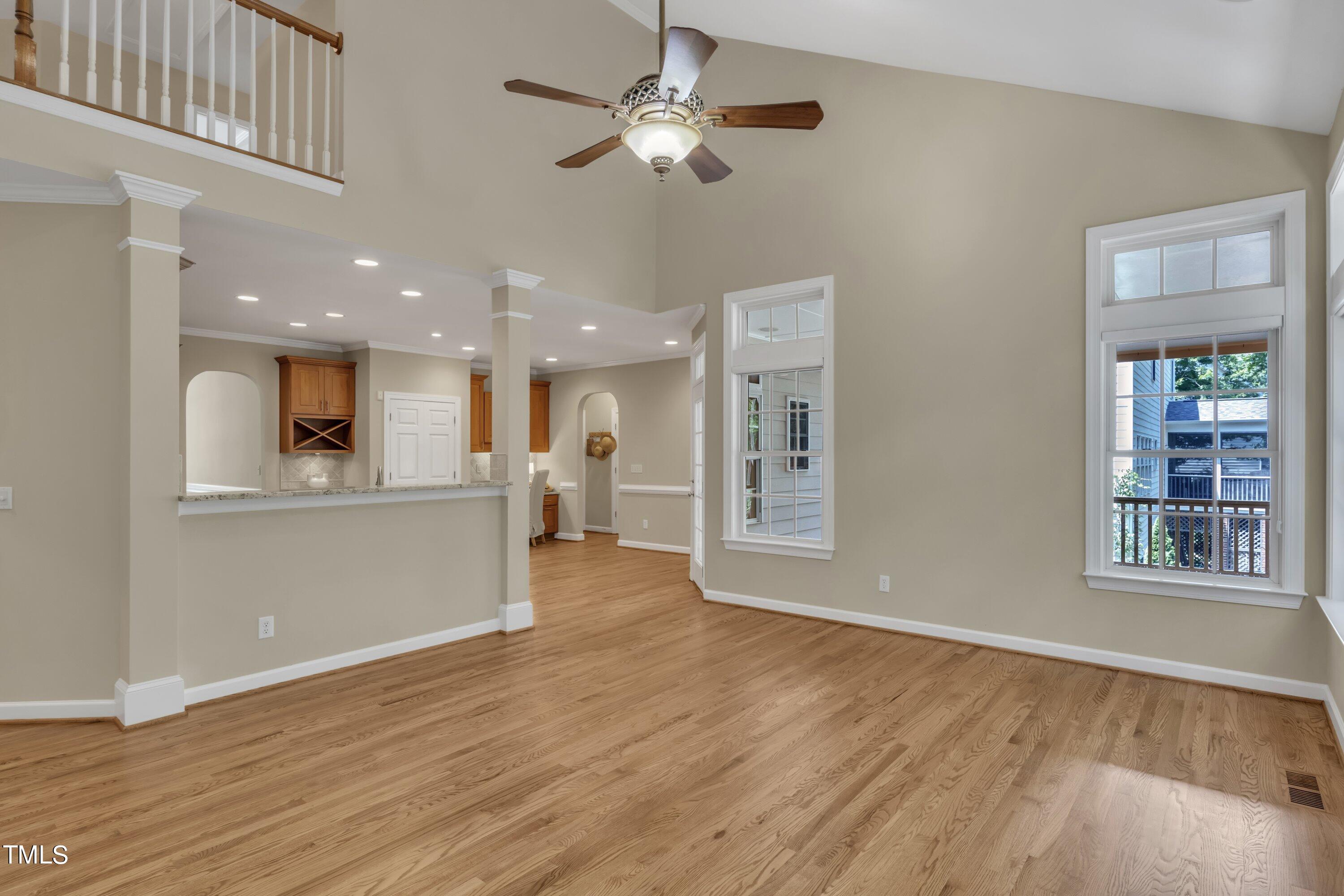 12208 Jasmine Cove Way Raleigh, NC 27614 - Photo 25 of 57 a view of an empty room with window and wooden floor