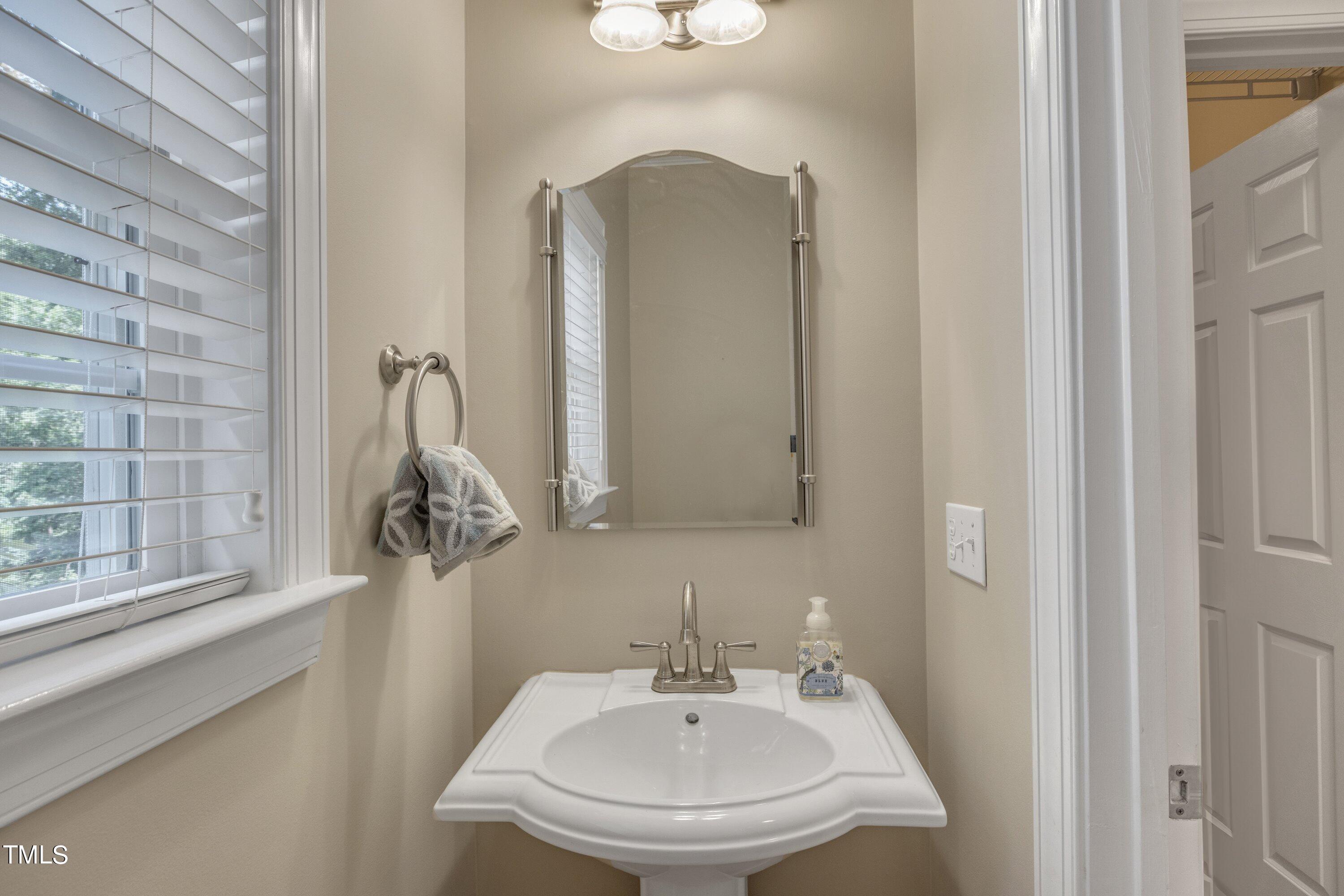 12208 Jasmine Cove Way Raleigh, NC 27614 - Photo 27 of 57 a bathroom with a sink and a mirror