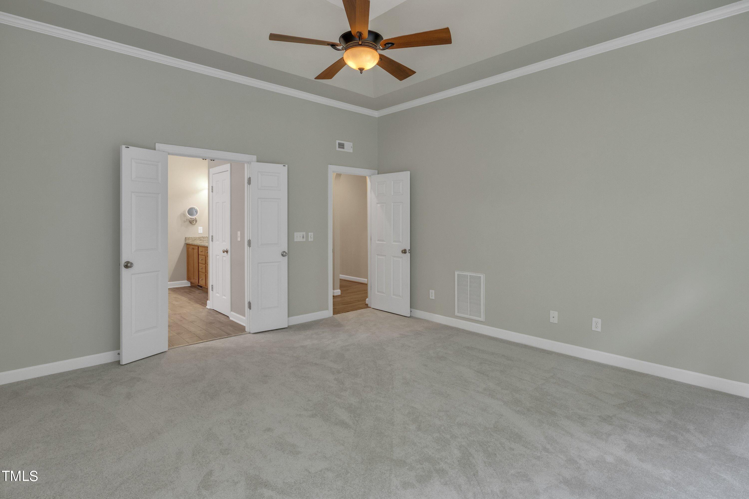 12208 Jasmine Cove Way Raleigh, NC 27614 - Photo 29 of 57 an empty room with closet and a chandelier fan