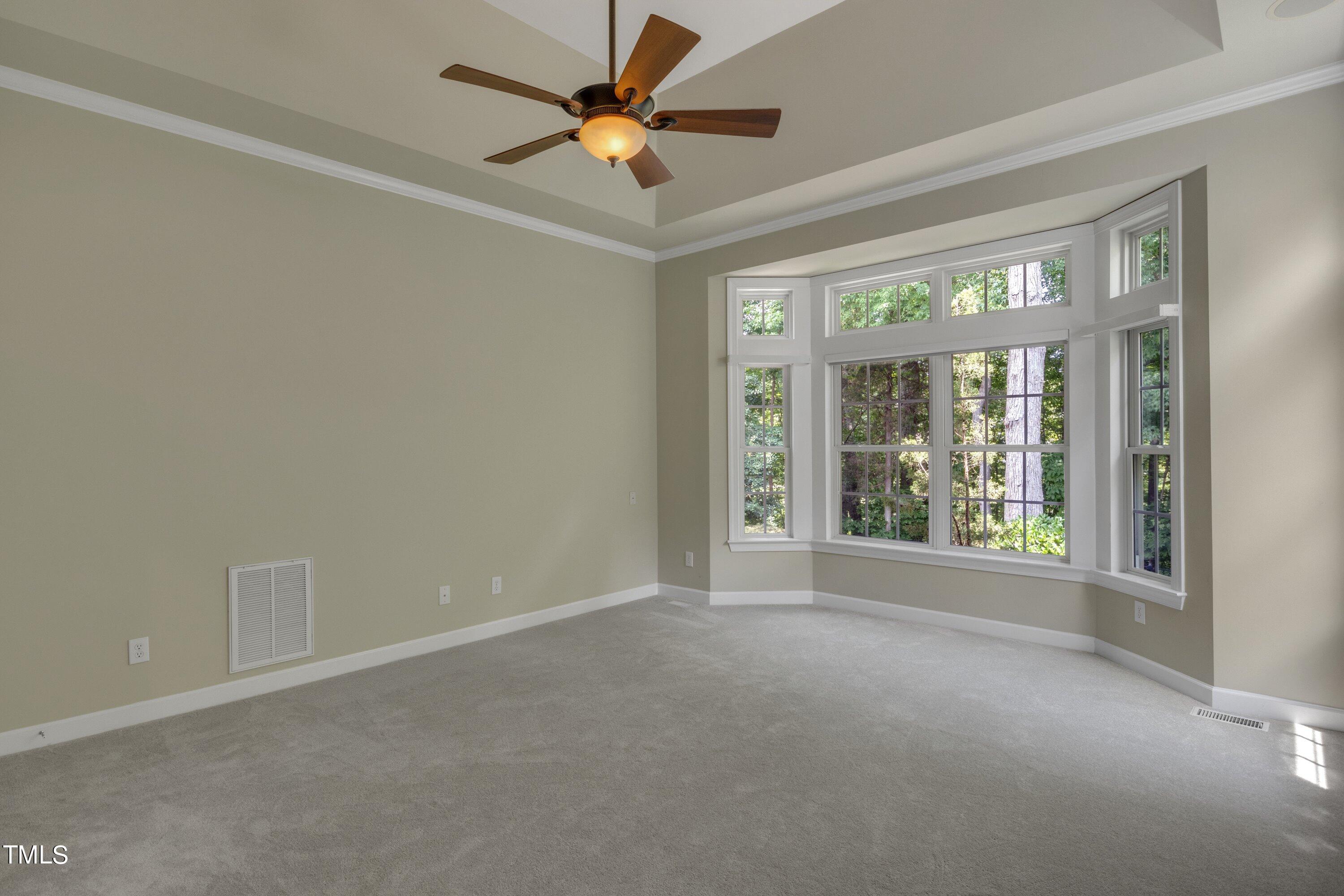 12208 Jasmine Cove Way Raleigh, NC 27614 - Photo 30 of 57 a view of a big room with windows and chandelier fan