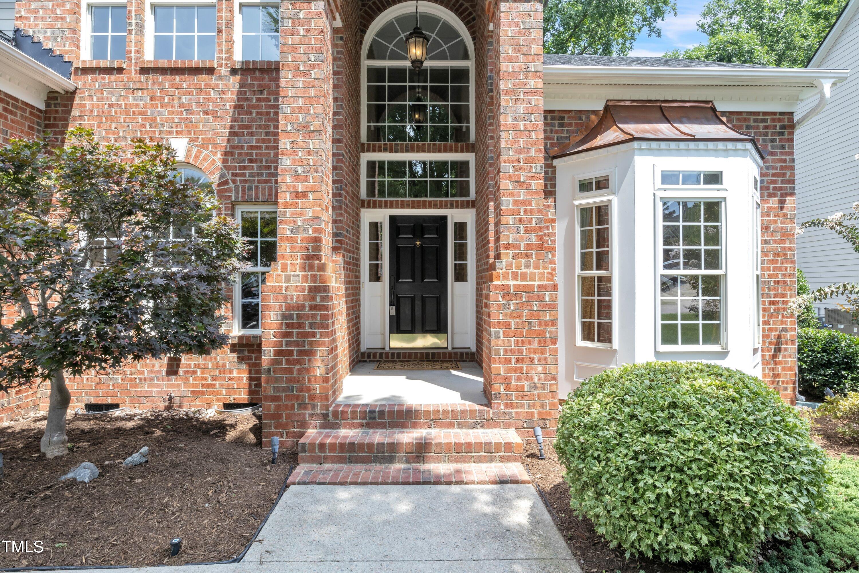 12208 Jasmine Cove Way Raleigh, NC 27614 - Photo 3 of 57 a front view of a house with a yard