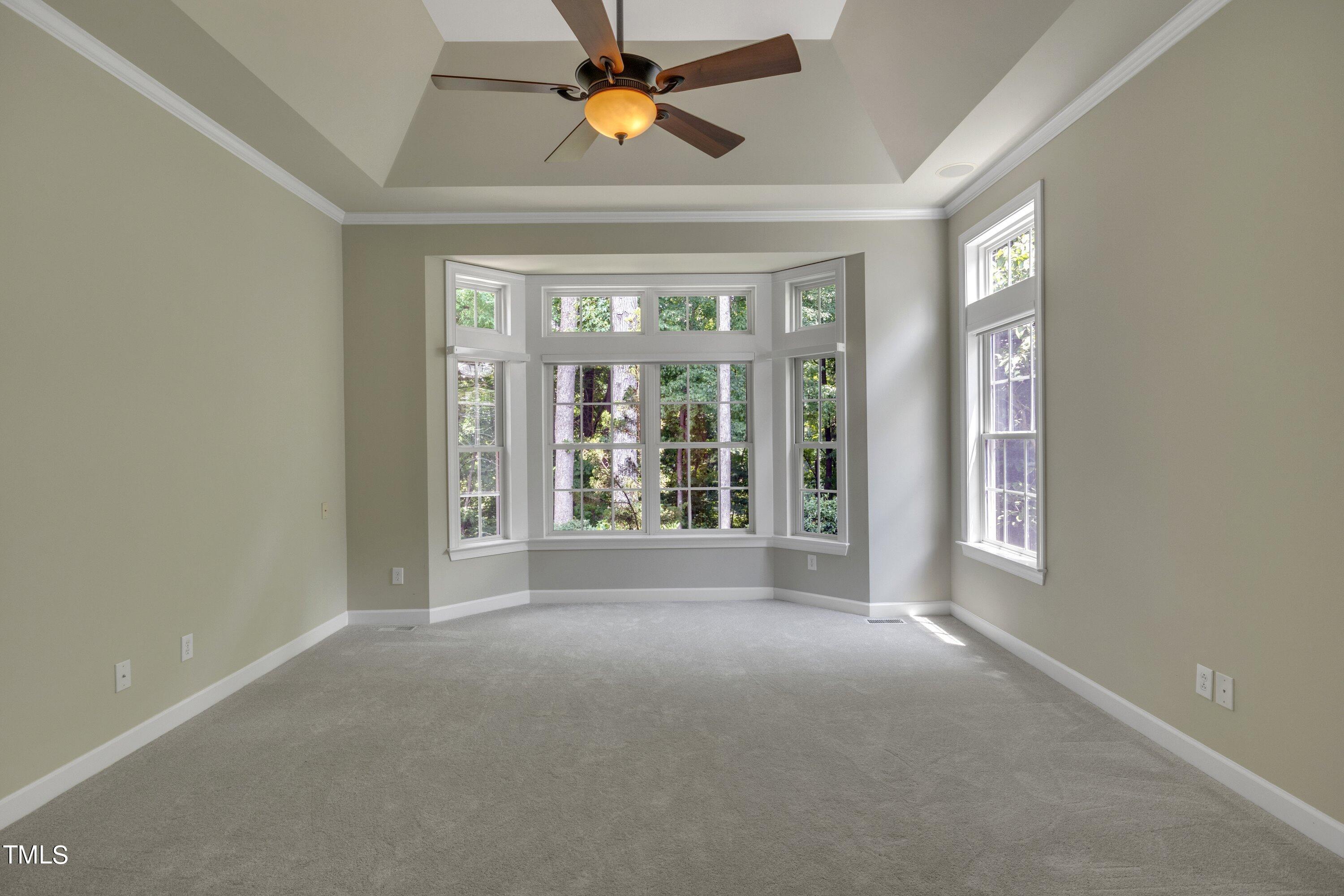 12208 Jasmine Cove Way Raleigh, NC 27614 - Photo 31 of 57 a view of n empty room with window and chandelier fan