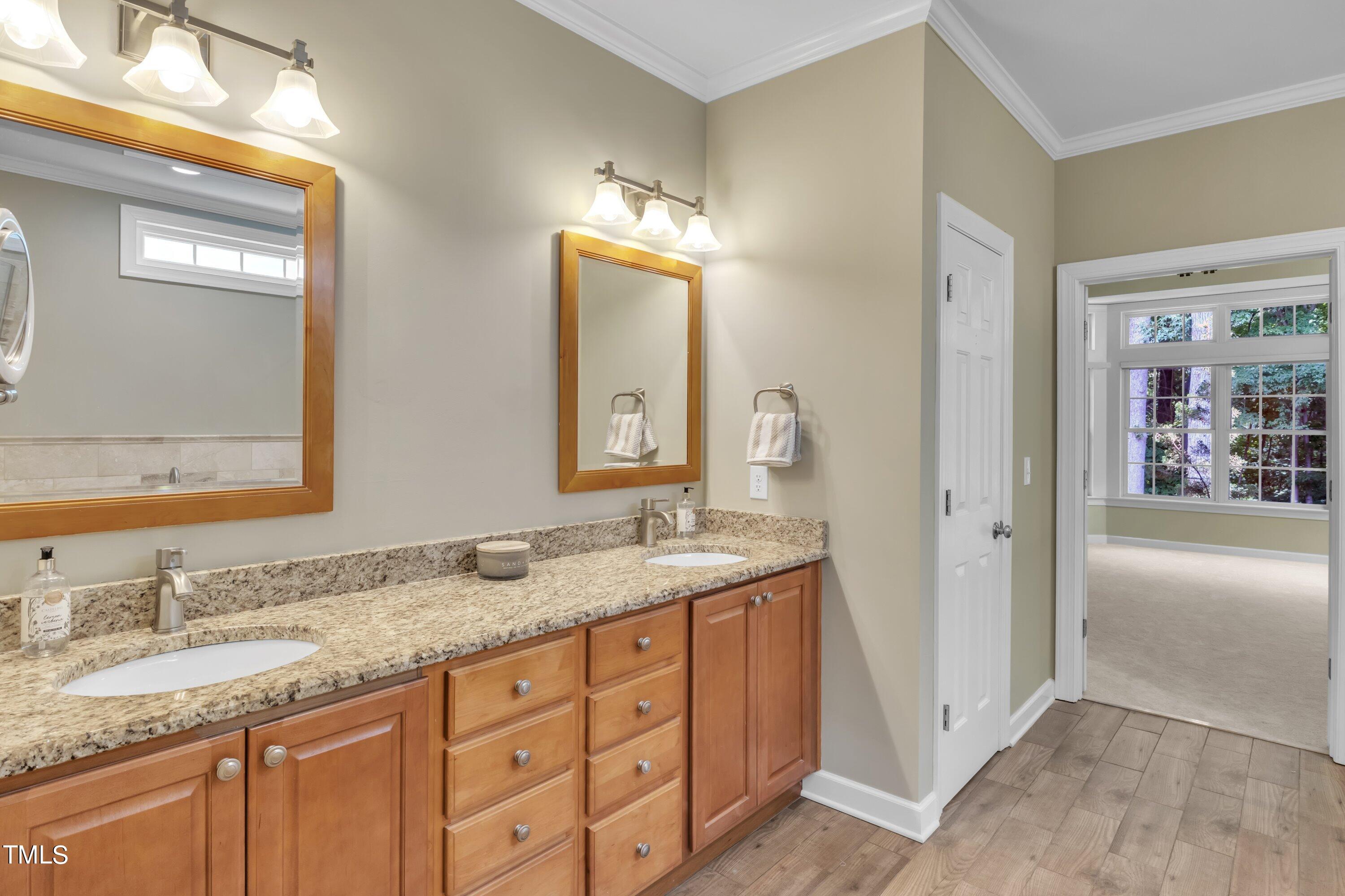 12208 Jasmine Cove Way Raleigh, NC 27614 - Photo 34 of 57 a bathroom with a granite countertop double vanity sink and a mirror