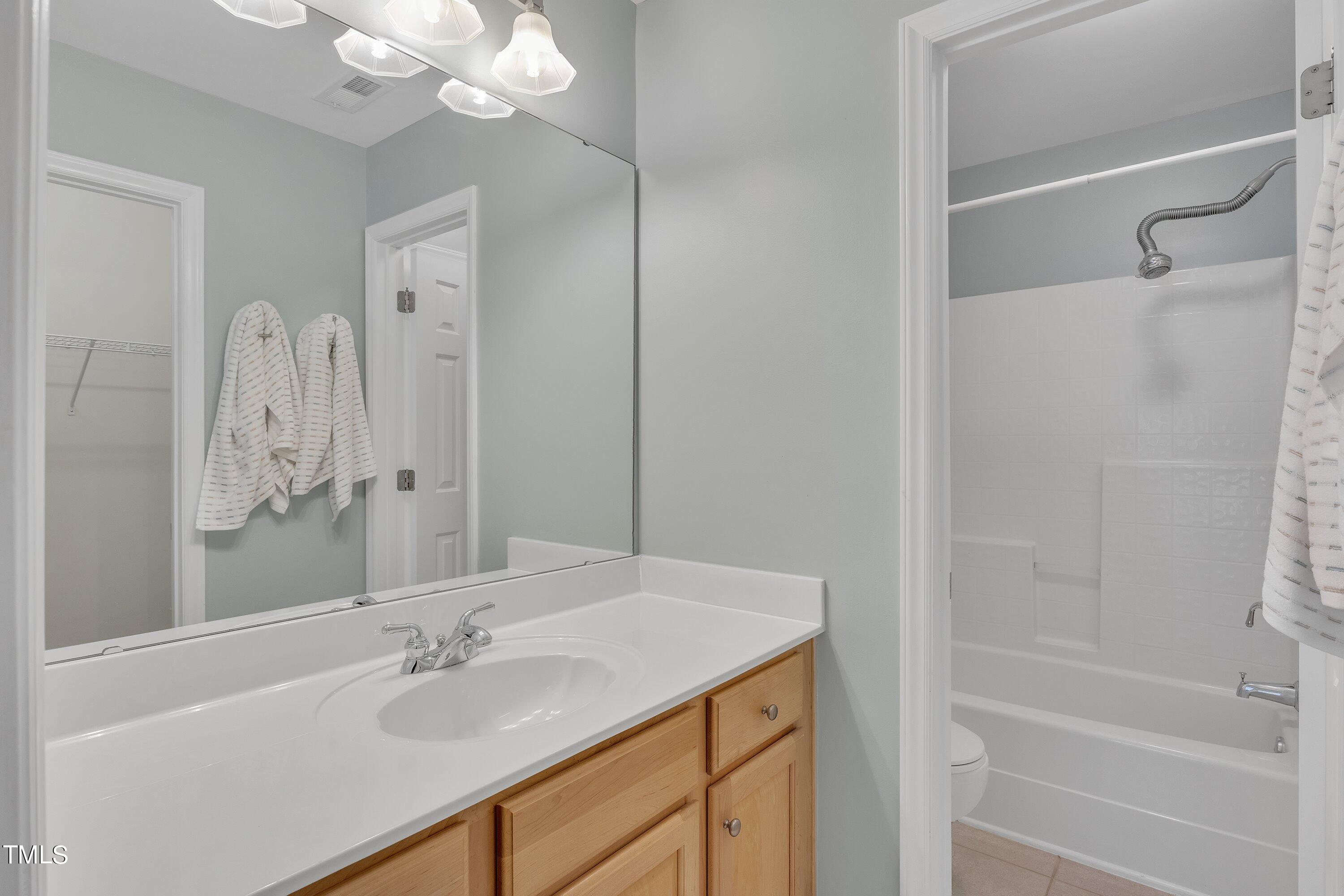 12208 Jasmine Cove Way Raleigh, NC 27614 - Photo 44 of 57 a bathroom with a granite countertop sink a toilet and shower