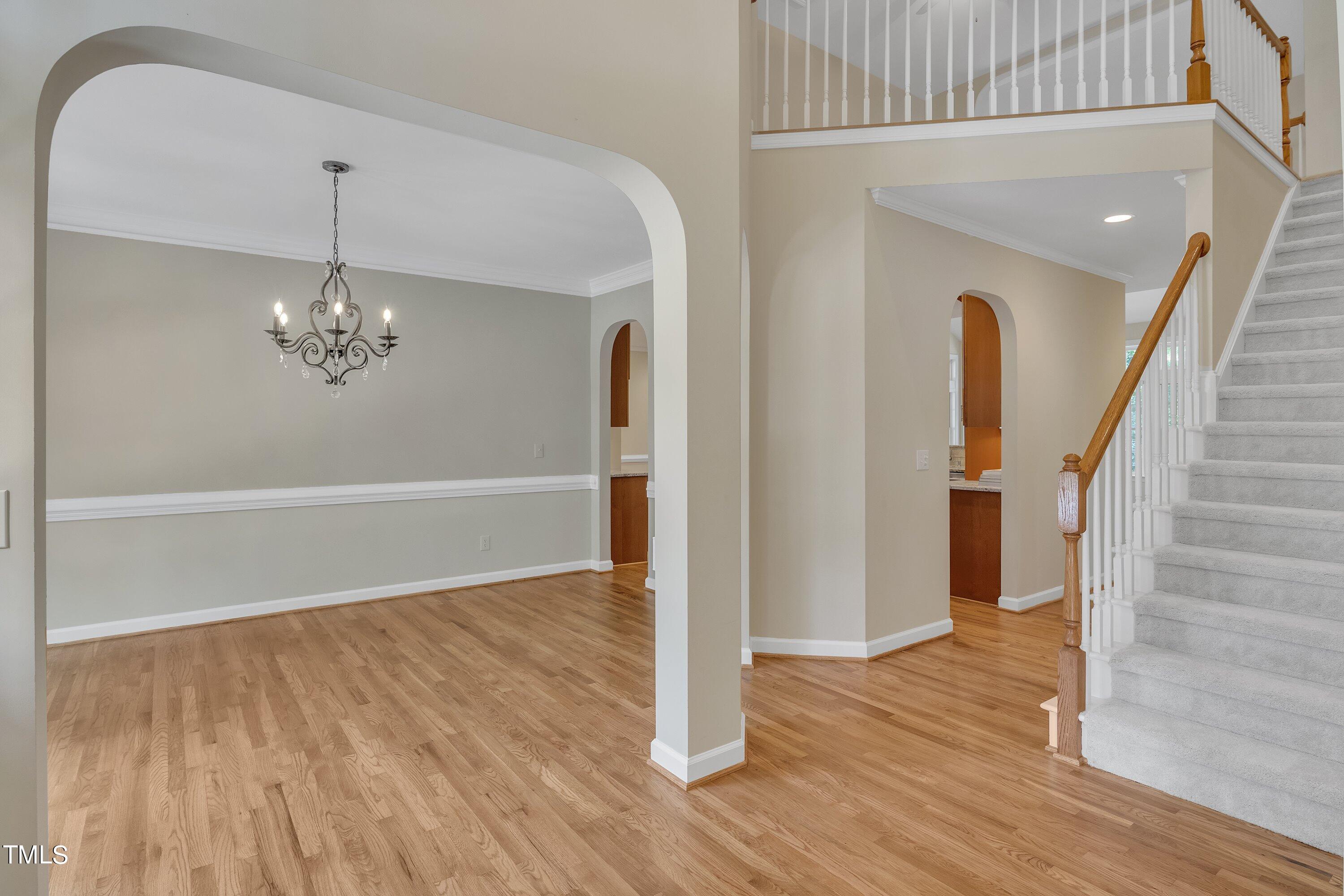 12208 Jasmine Cove Way Raleigh, NC 27614 - Photo 5 of 57 wooden floor in an empty room with a window