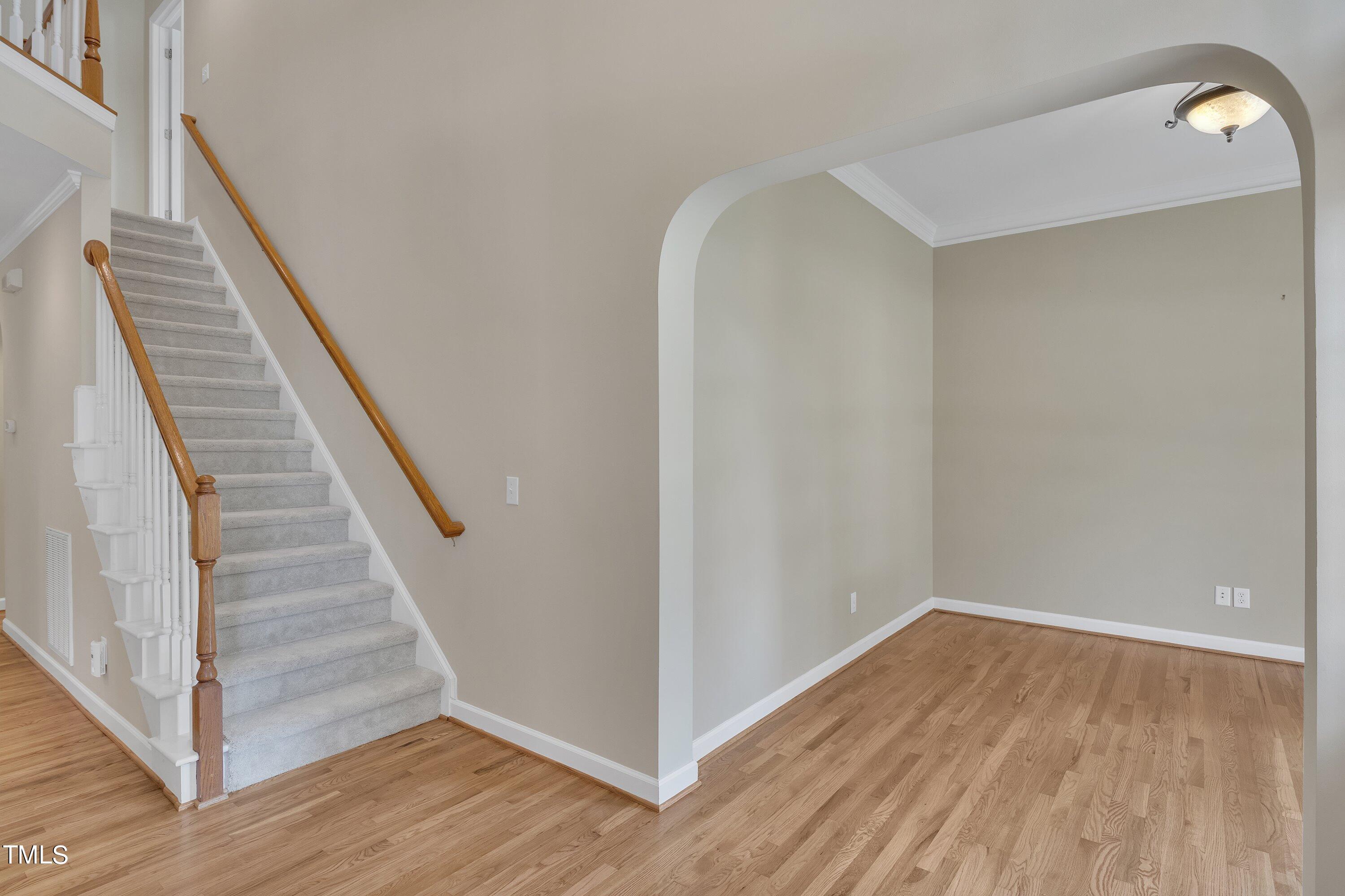 12208 Jasmine Cove Way Raleigh, NC 27614 - Photo 6 of 57 a view of a hallway with wooden floor and entryway