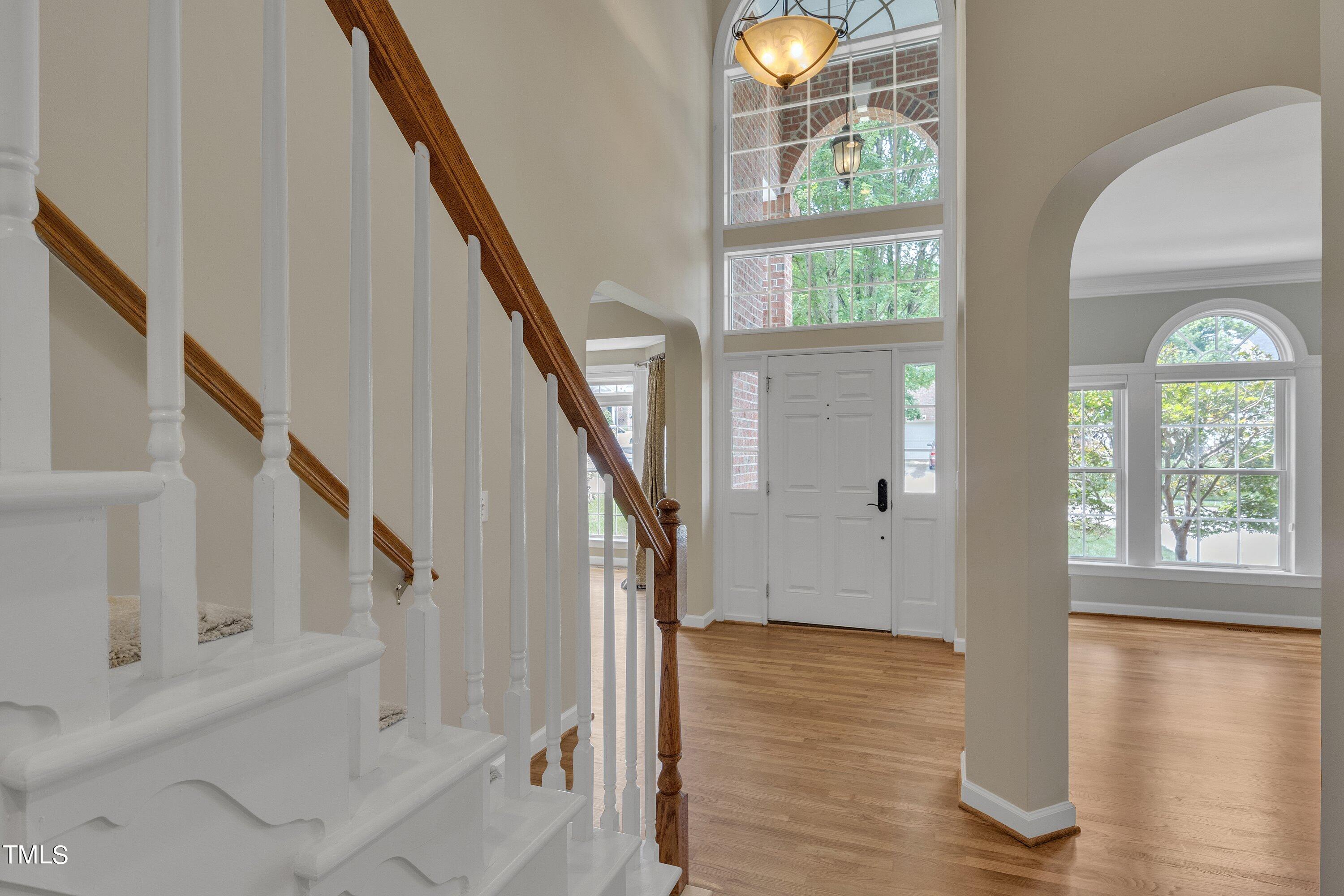 12208 Jasmine Cove Way Raleigh, NC 27614 - Photo 9 of 57 a view of entryway with wooden floor and front door