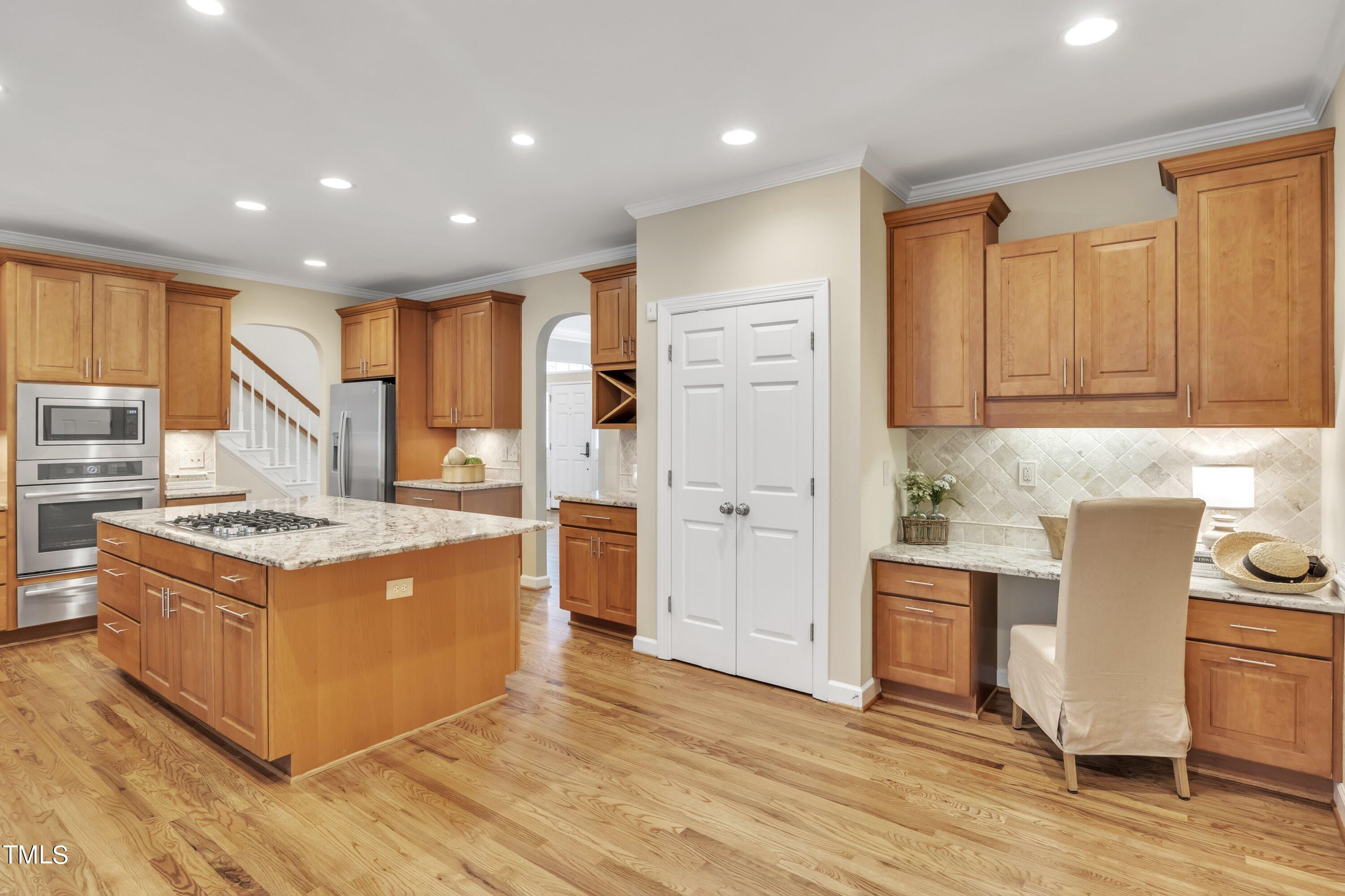 12208 Jasmine Cove Way Raleigh, NC 27614 - Photo 10 of 57 a kitchen with stainless steel appliances granite countertop a stove and a refrigerator