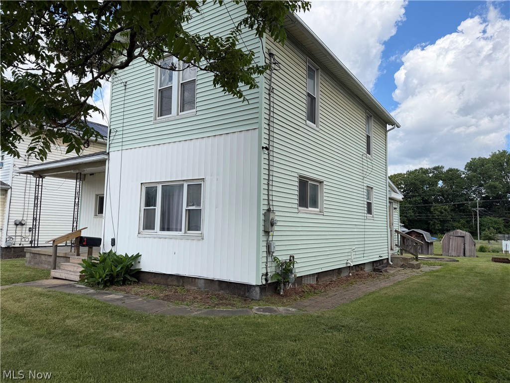 32 Cherry Road Northwest Massillon, OH 44646 - Photo 2 of 12 Two-story residence featuring light green horizontal siding and white vertical siding