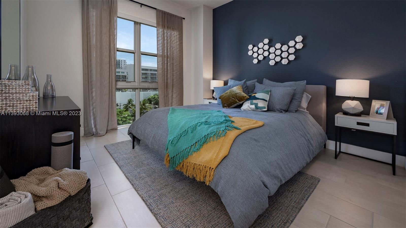 2701 Biscayne Boulevard, Unit 6217 Miami, FL 33137 - Photo 13 of 45 a bedroom with a bed mirror and a window