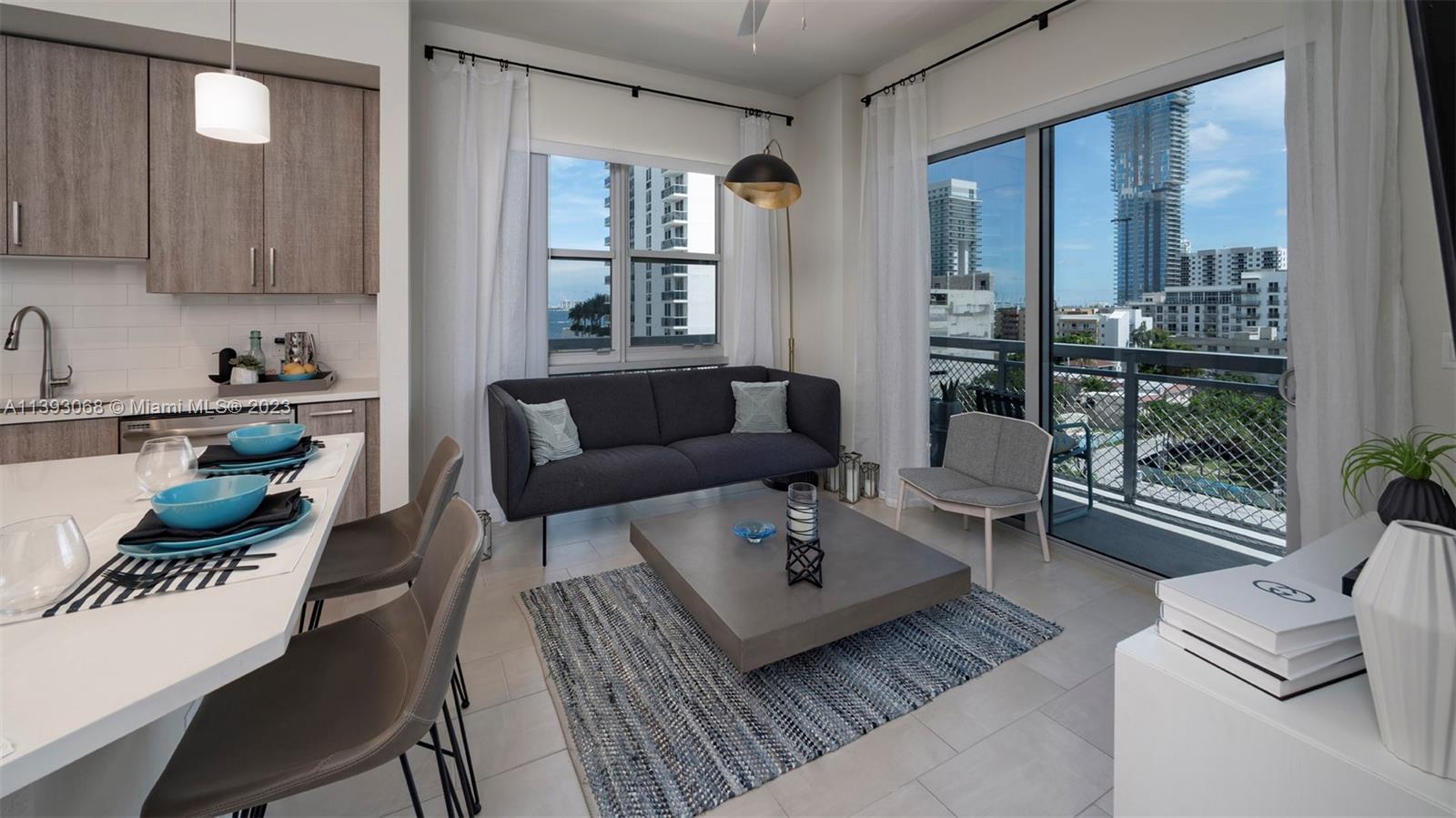 2701 Biscayne Boulevard, Unit 6217 Miami, FL 33137 - Photo 23 of 45 a living room with furniture and a floor to ceiling window