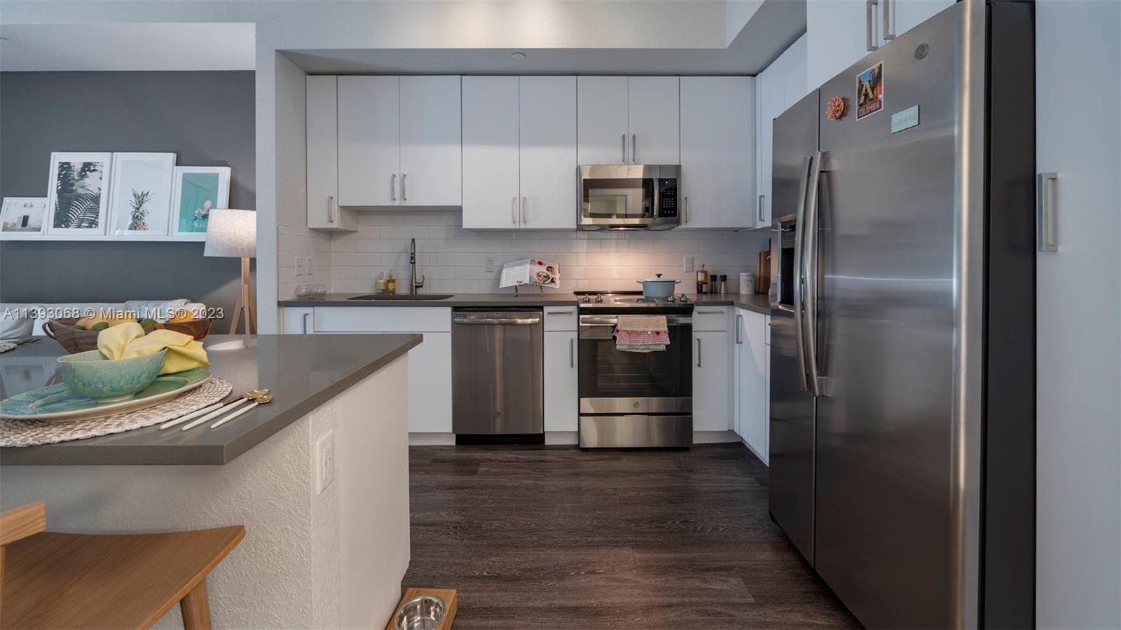 2701 Biscayne Boulevard, Unit 6217 Miami, FL 33137 - Photo 10 of 45 a kitchen with stainless steel appliances granite countertop a refrigerator a stove a sink and dishwasher