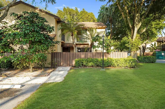 a view of a house with a yard and sitting area