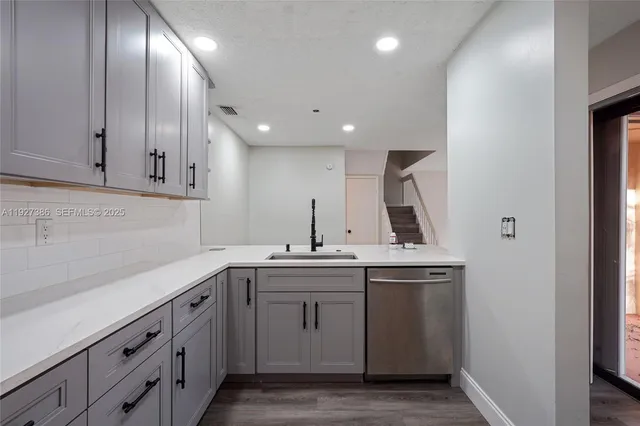 a kitchen with a sink and cabinets