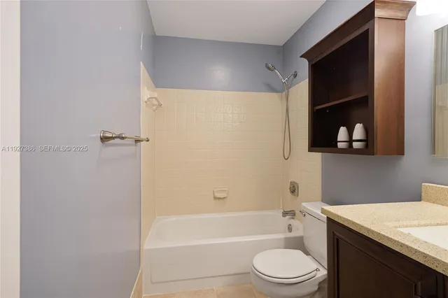 a bathroom with a toilet a sink and bathtub