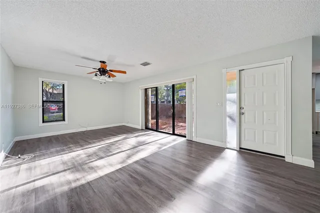 a view of a livingroom with wooden floor and window