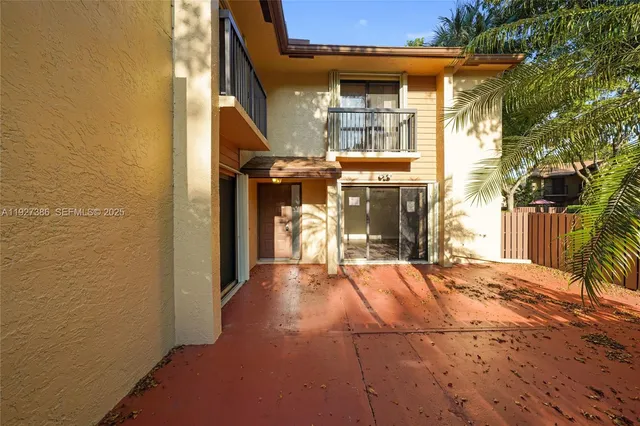 a view of a building with door and outdoor space