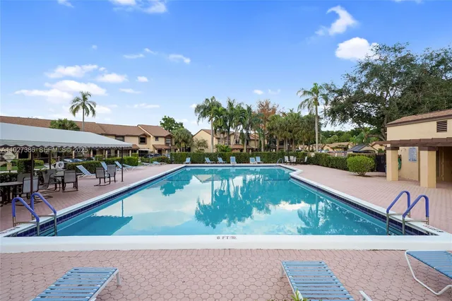 a view of swimming pool with outdoor seating