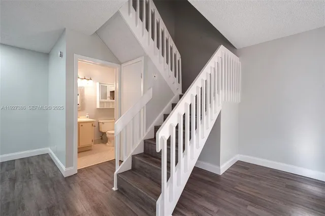 a view of staircase with wooden floor and stairs