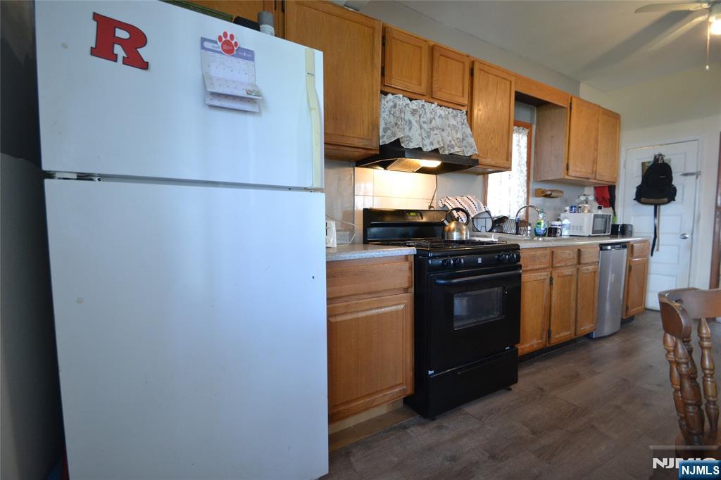 655 Chestnut Street Kearny, NJ 07032 - Photo 13 of 31 a kitchen with stainless steel appliances granite countertop a refrigerator a sink a stove and a refrigerator