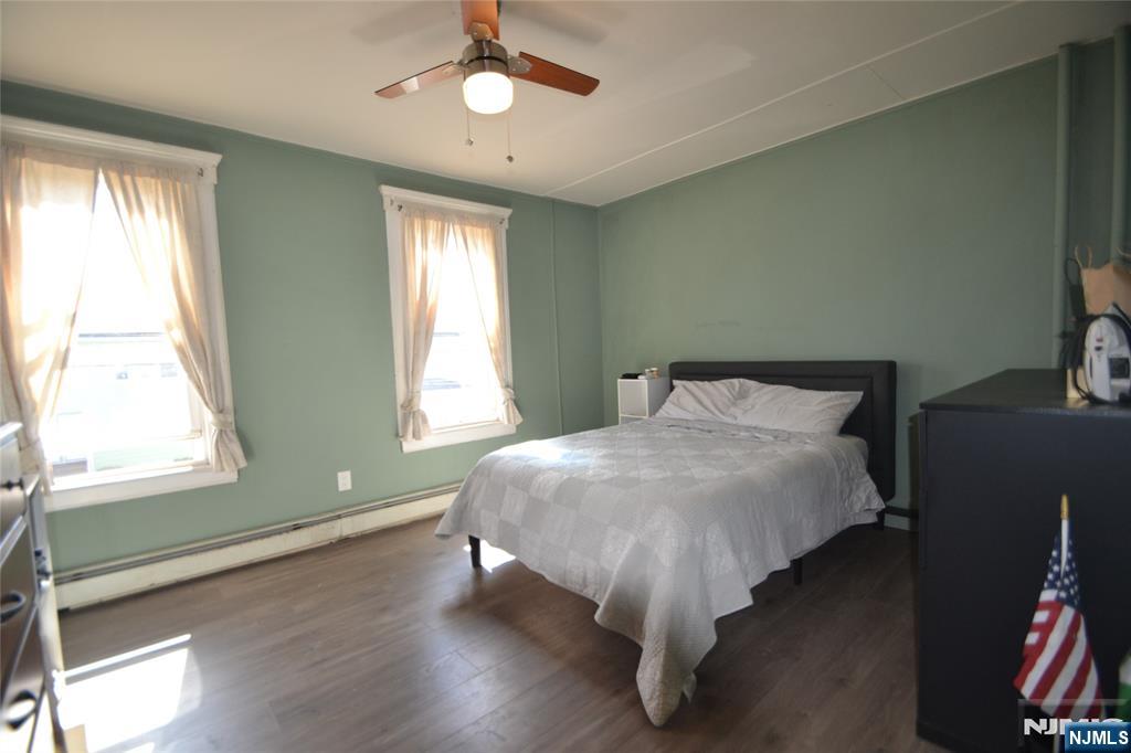 655 Chestnut Street Kearny, NJ 07032 - Photo 15 of 31 a bed sitting in a bedroom next to a window