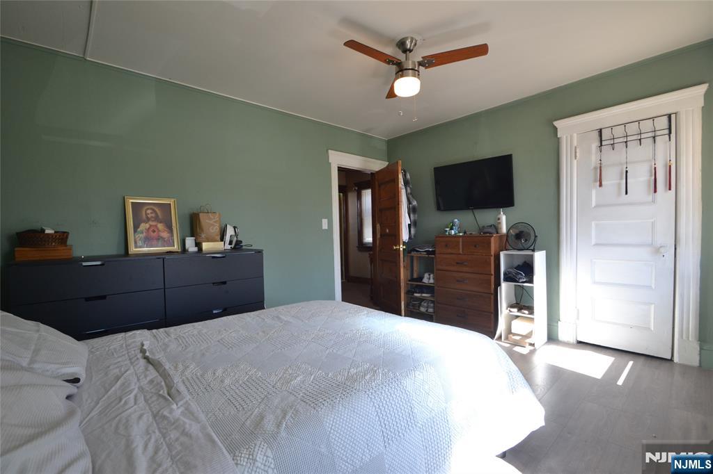 655 Chestnut Street Kearny, NJ 07032 - Photo 16 of 31 a bed room with a bed and a television