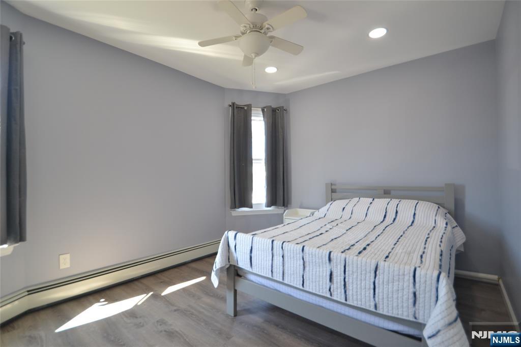 655 Chestnut Street Kearny, NJ 07032 - Photo 17 of 31 a bed sitting in a bedroom next to a window