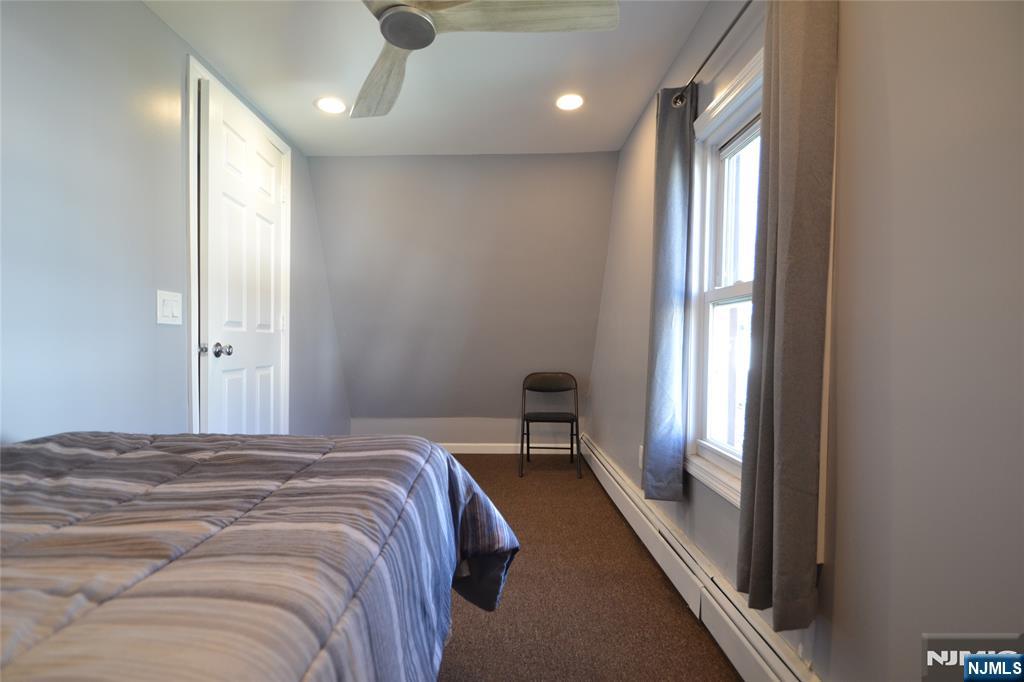 655 Chestnut Street Kearny, NJ 07032 - Photo 24 of 31 a bedroom with a bed and a large window