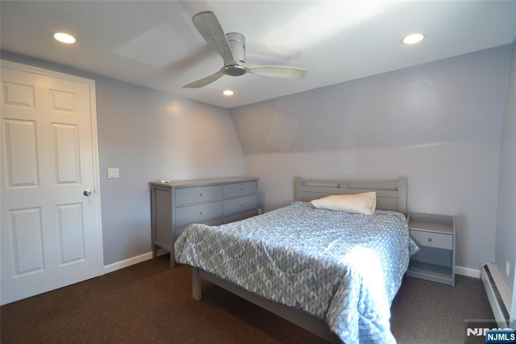 655 Chestnut Street Kearny, NJ 07032 - Photo 26 of 31 a bedroom with a bed and a chandelier