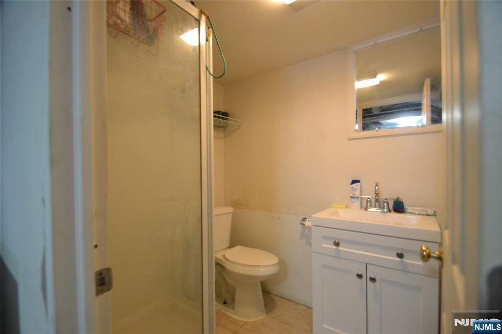 655 Chestnut Street Kearny, NJ 07032 - Photo 29 of 31 a bathroom with a toilet sink and a mirror