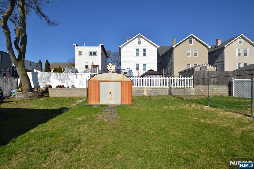655 Chestnut Street Kearny, NJ 07032 - Photo 5 of 31 a view of a house with a big yard and large trees
