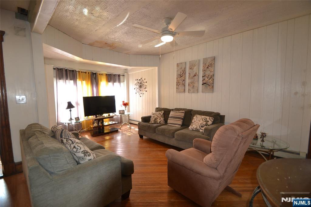 655 Chestnut Street Kearny, NJ 07032 - Photo 8 of 31 a living room with furniture and a flat screen tv