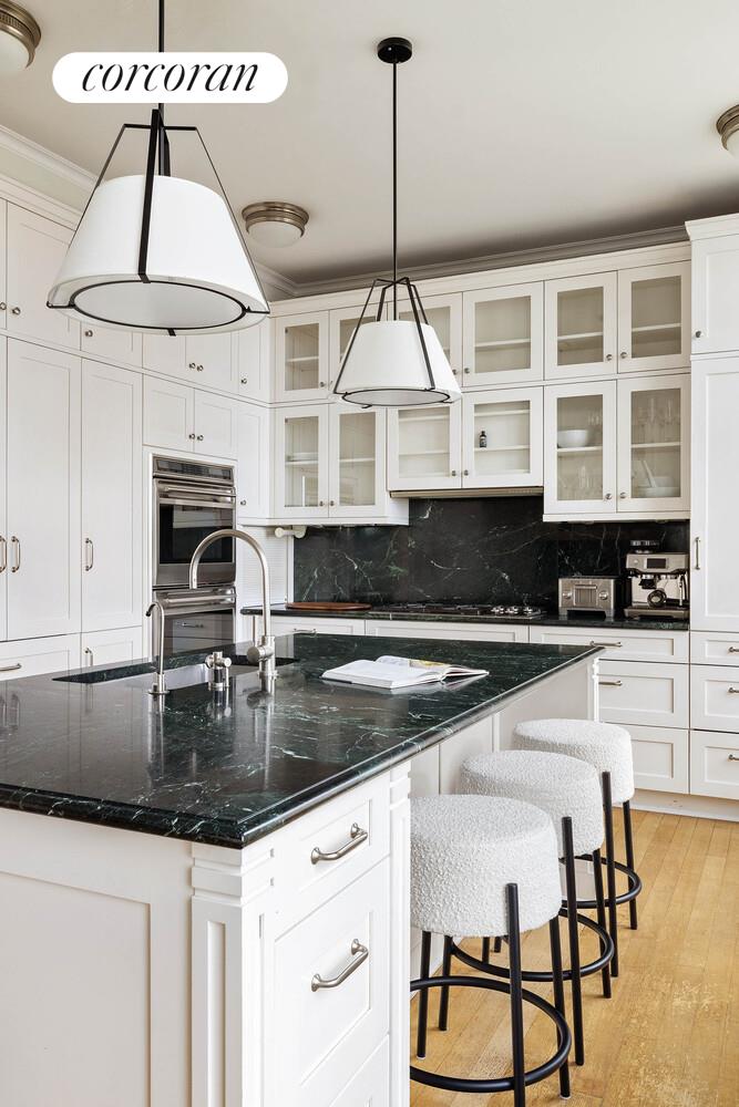 15 Central Park West, Unit 27D Manhattan, NY 10023 - Photo 14 of 30 a kitchen with stainless steel appliances granite countertop a stove a sink and a granite counter tops