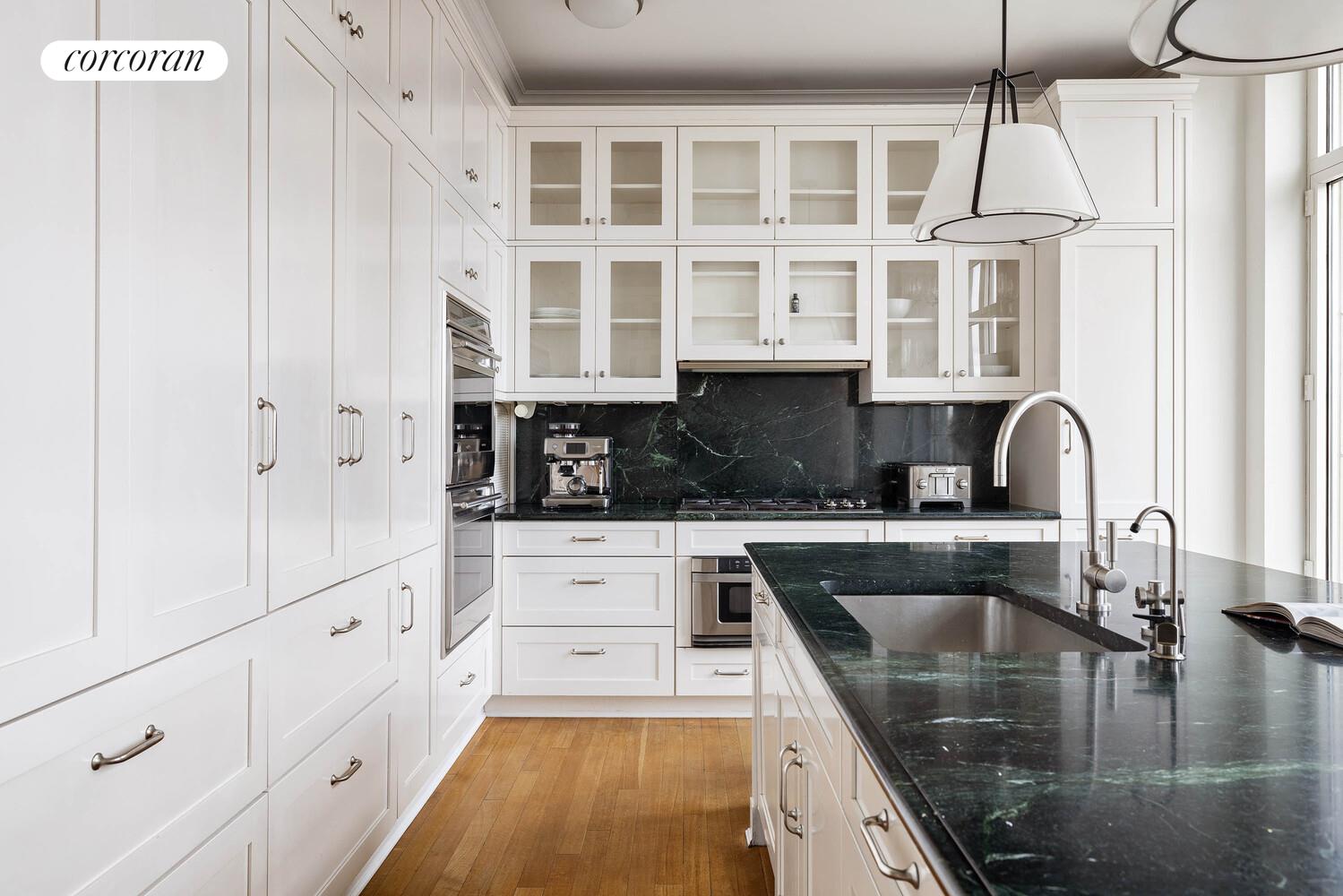 15 Central Park West, Unit 27D Manhattan, NY 10023 - Photo 15 of 30 a kitchen with stainless steel appliances granite countertop a sink and cabinets