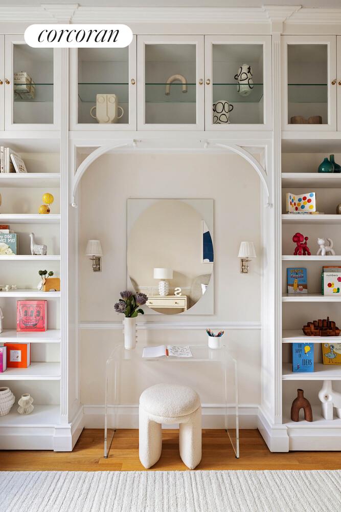 15 Central Park West, Unit 27D Manhattan, NY 10023 - Photo 25 of 30 a living room with furniture and a table with bookshelf