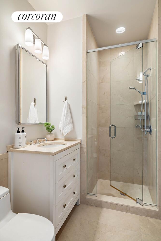 15 Central Park West, Unit 27D Manhattan, NY 10023 - Photo 26 of 30 a bathroom with a sink a toilet and shower