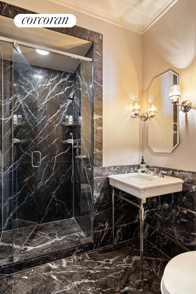 15 Central Park West, Unit 27D Manhattan, NY 10023 - Photo 27 of 30 a bathroom with a sink and a mirror