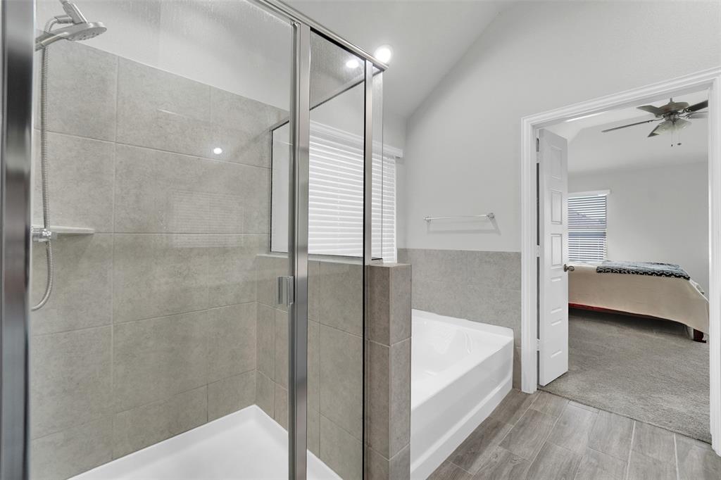 1340 Collett Sublett Road Kennedale, TX 76060 - Photo 12 of 25 Glass-enclosed shower with a multi-function showerhead, complemented by a separate soaking tub and wood-finish tile flooring