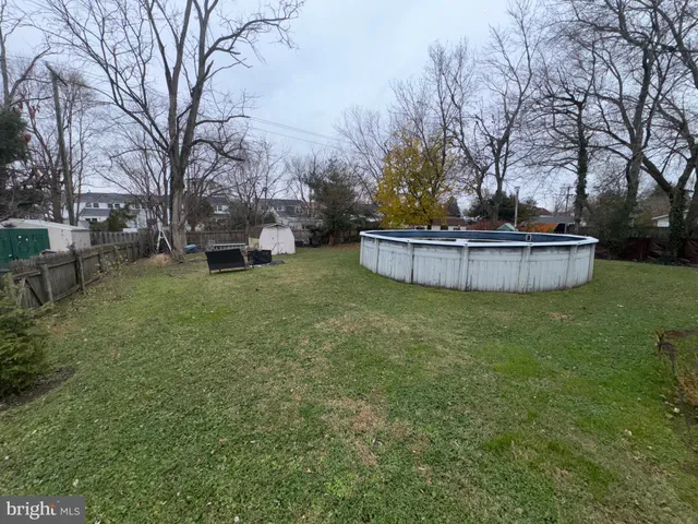 a kitchen with granite countertop a stove a sink dishwasher and white cabinets