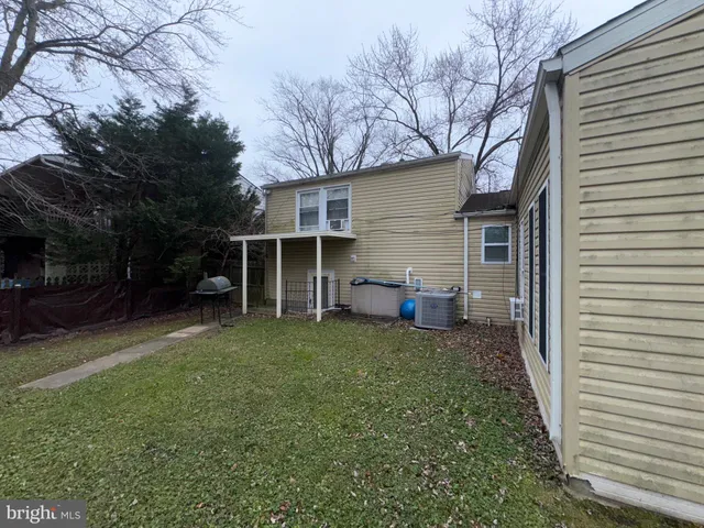 a living room with furniture a window and a flat screen tv