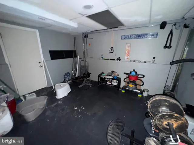 a bedroom with a bed and a television