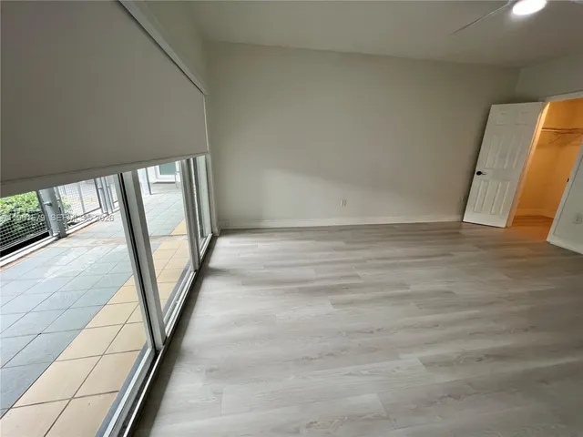 an empty room with wooden floor and closet