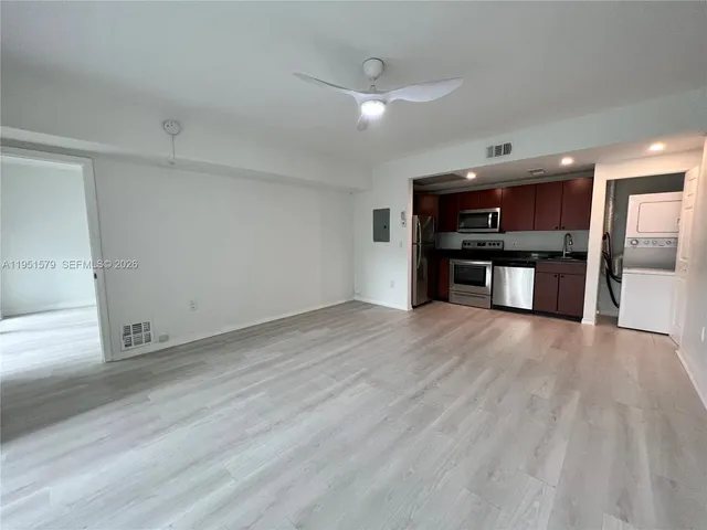 a view of a kitchen with a sink a refrigerator and a stove