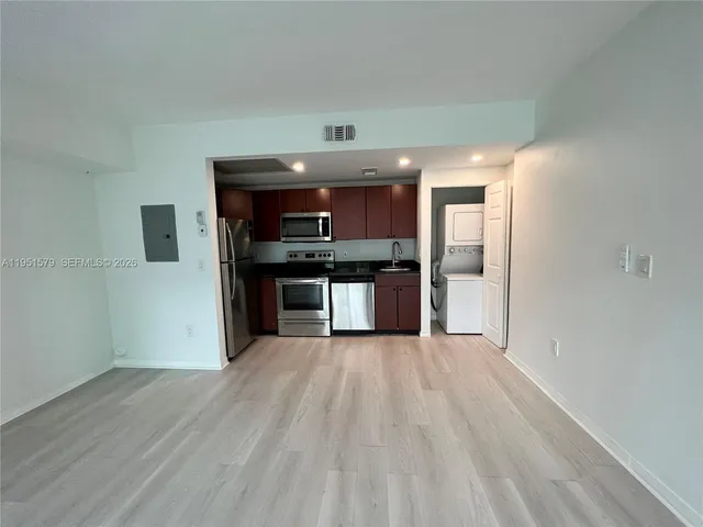 a kitchen with stainless steel appliances granite countertop a refrigerator stove a sink and a granite counter tops