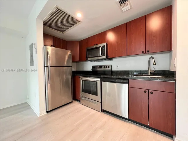 a kitchen with a stove and a microwave