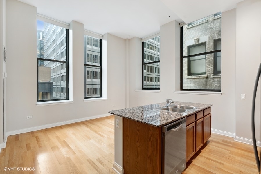 8 West Monroe Street, Unit 500 Chicago, IL 60603 - Photo 3 of 14 a bathroom with a granite countertop sink and a window