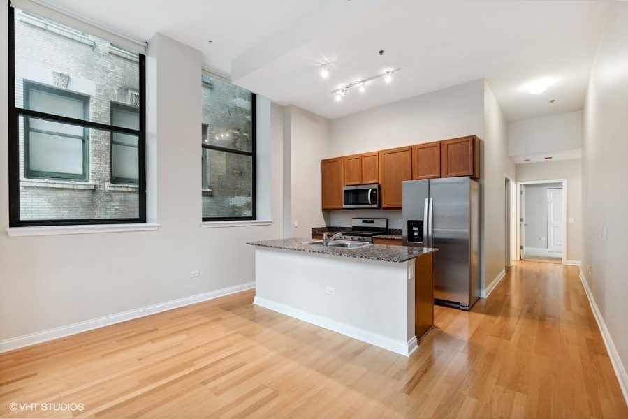 8 West Monroe Street, Unit 500 Chicago, IL 60603 - Photo 5 of 14 a kitchen with stainless steel appliances a refrigerator and a stove top oven