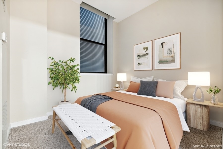 8 West Monroe Street, Unit 500 Chicago, IL 60603 - Photo 8 of 14 a bedroom with a bed and a potted plant