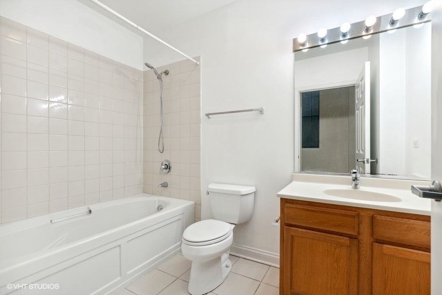 8 West Monroe Street, Unit 500 Chicago, IL 60603 - Photo 9 of 14 a bathroom with a sink a toilet and shower