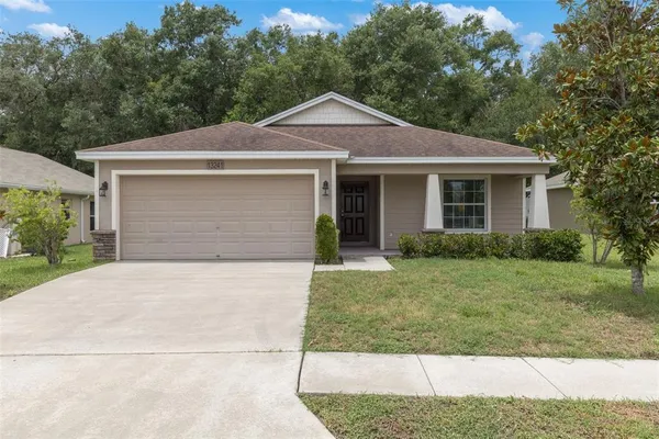 a front view of a house with a yard